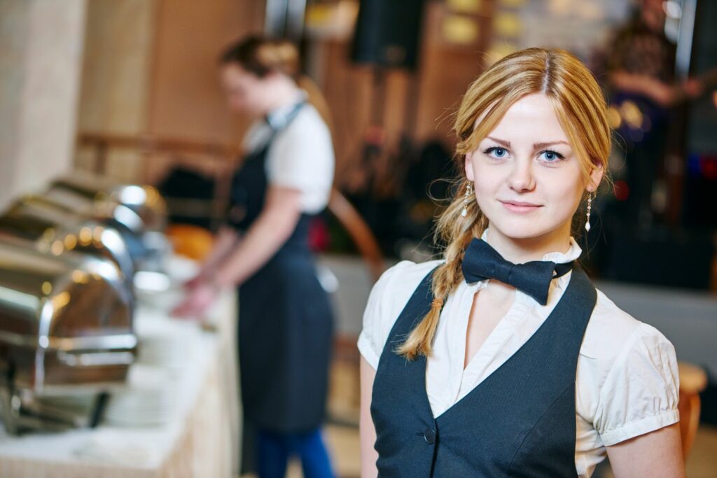 Catering staff with girl looking towards camera