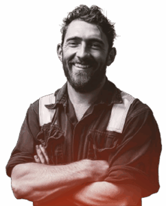 Smiling worker in overalls, arms crossed