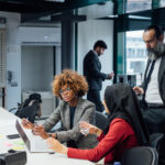 Diverse professionals meeting and collaborating in an office.
