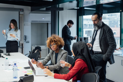 Diverse professionals meeting and collaborating in an office.