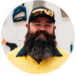 Smiling trade worker with a beard in high-vis shirt