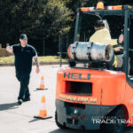 Forklift training session with instructor guiding vehicle operation
