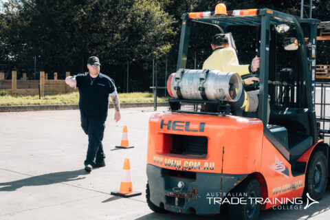 Forklift training session with instructor guiding vehicle operation