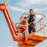 Operator working at height using elevated work platform lift