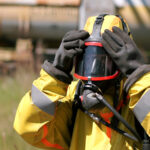 Hazmat worker wearing full protective respirator safety equipment