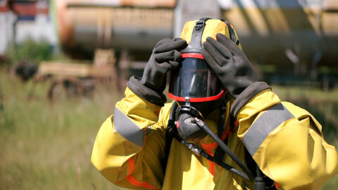 Hazmat worker wearing full protective respirator safety equipment