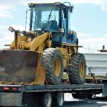 Front end loader secured on truck during heavy transport training
