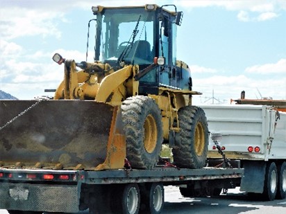 Front end loader secured on truck during heavy transport training