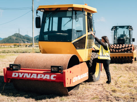 Road roller training with trainee climbing Dynapac compactor