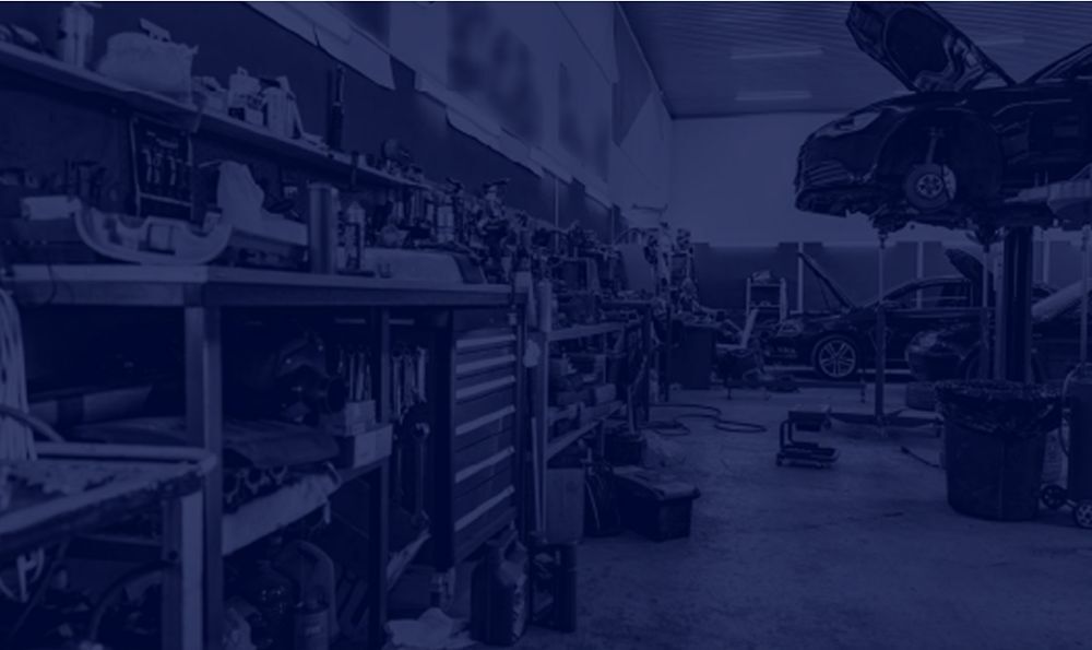 Professional auto repair garage with car on hydraulic lift