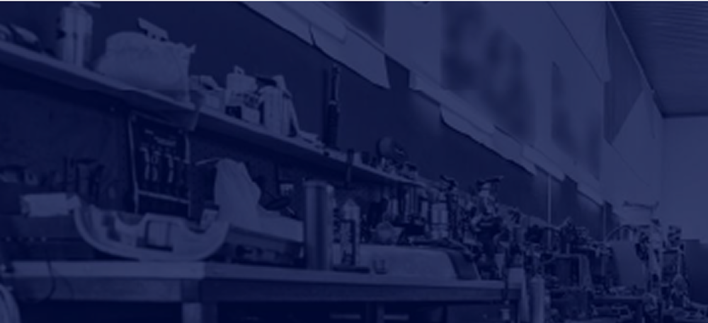 Blue-tinted workshop with tools on shelves.